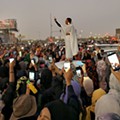 Alaa Salah stands on a car leading chants during a protest demanding that Sudanese President Omar al-Bashir step down in Khartoum, Sudan, on April 8, 2019.jpg